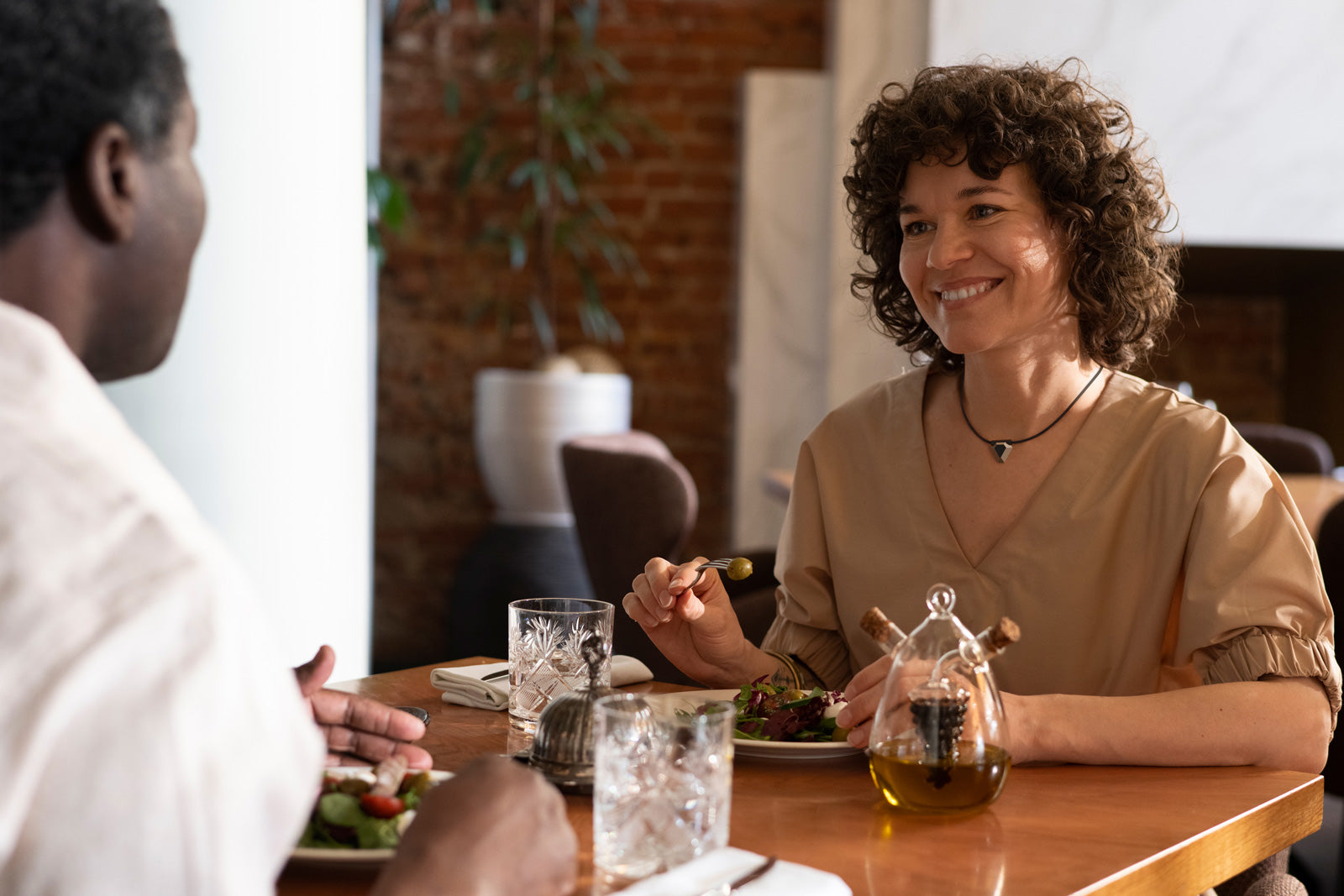 Woman dining while wearing the Odyss N1 necklace